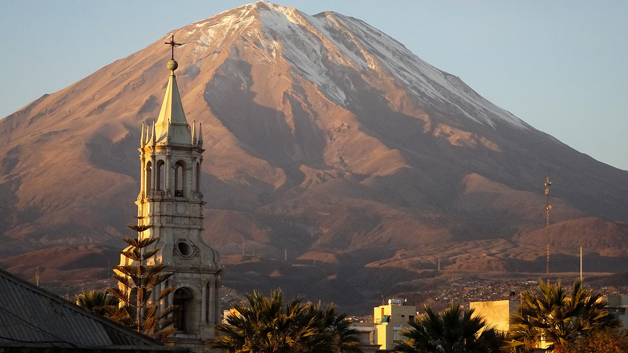 Image of a church in Arequipa against a mountain backdrop - KILROY