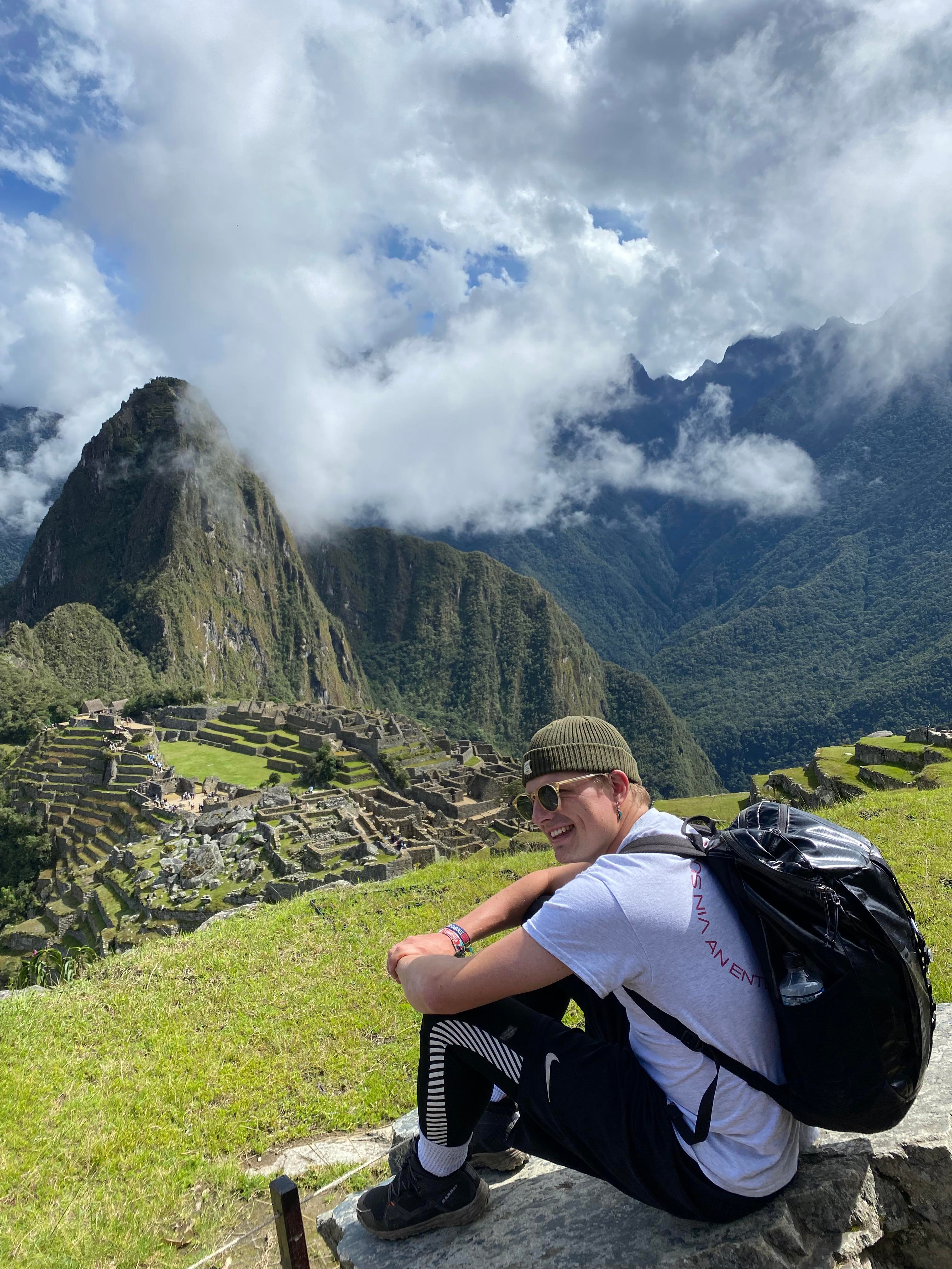 Image of a male traveller overlooking the ruins of Machu Picchu - KILROY