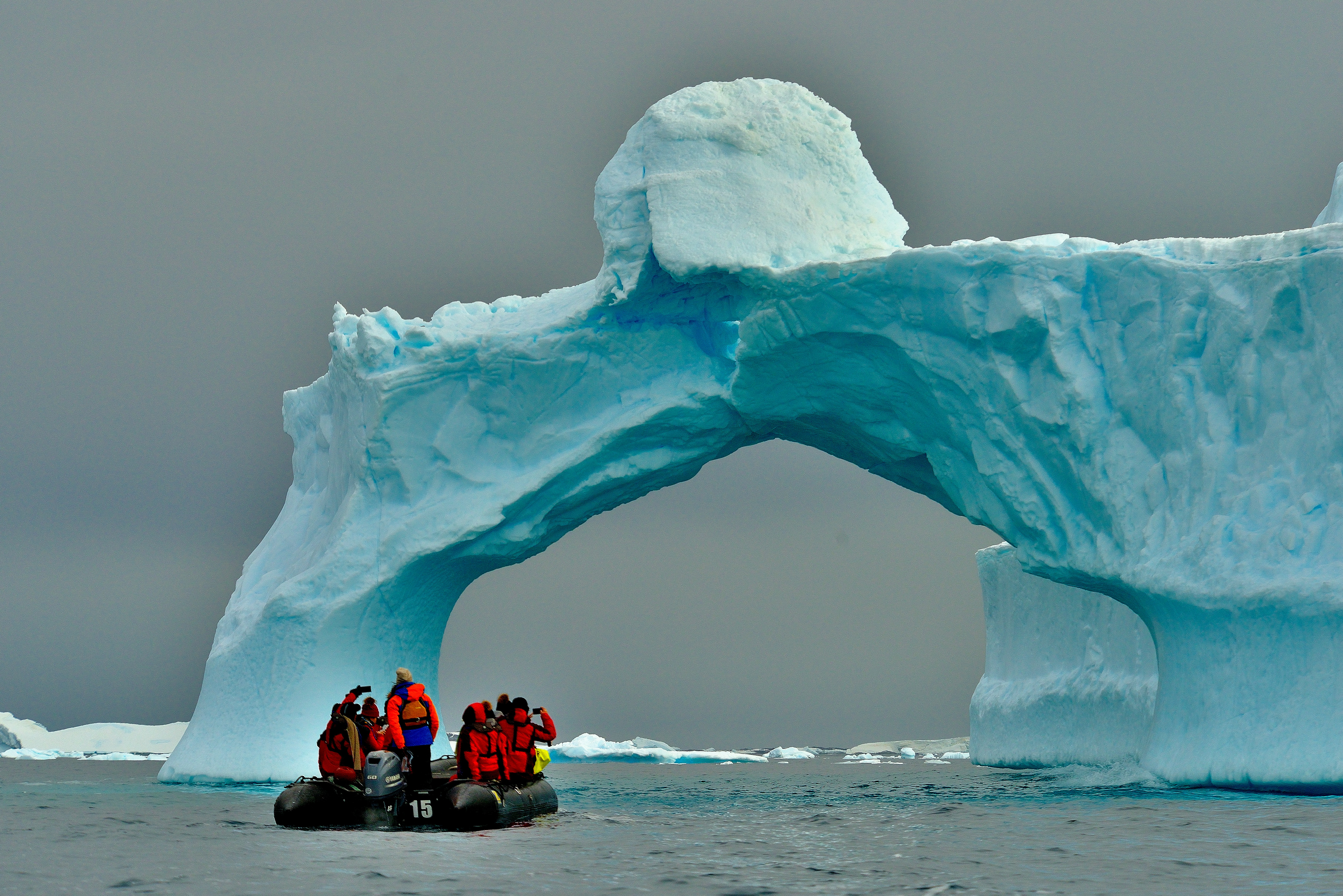 Image of a Zodiac boat near an iceberg in Antarctica - KILROY