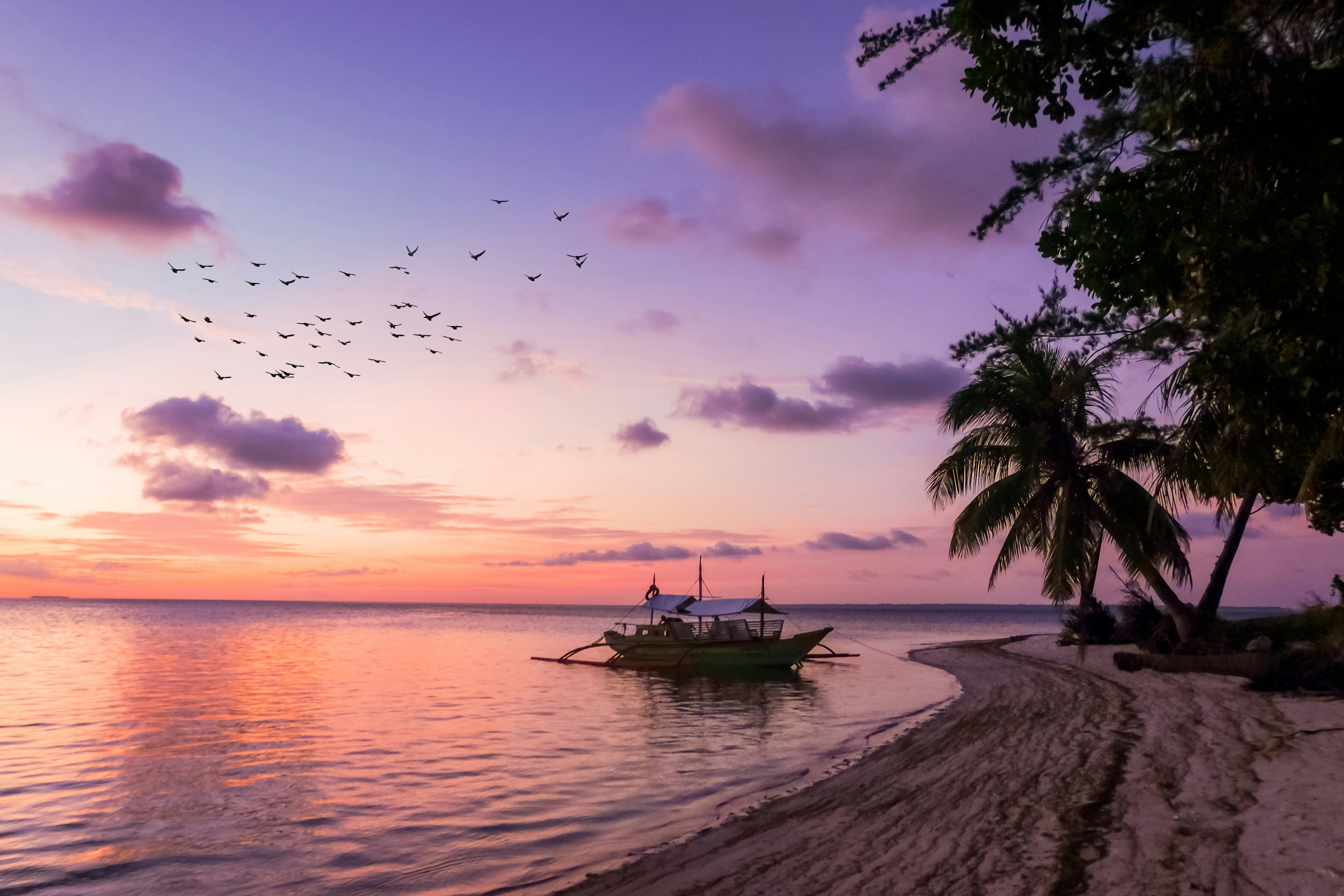 Image of a sail boat near a beach on the island of Balabac in the Philippines - KILROY