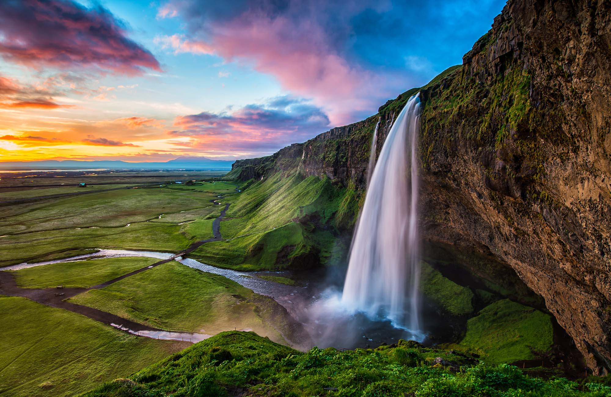 Image of a waterfall at sunset in Iceland - KILROY