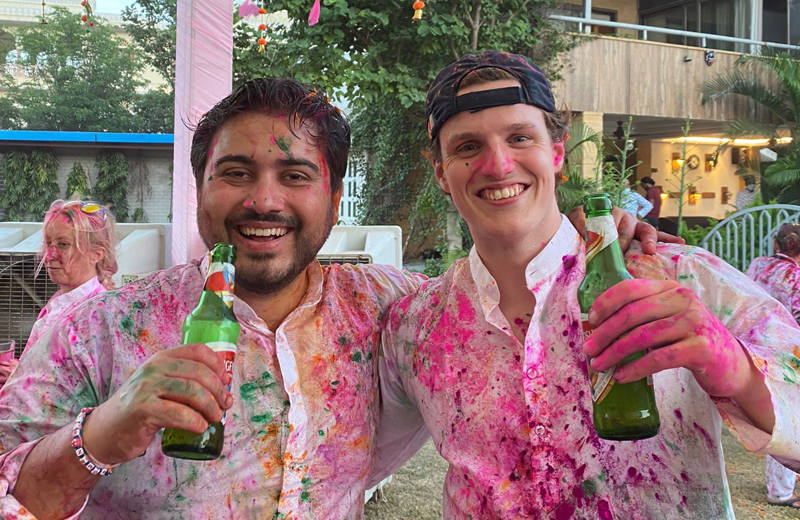 Image of two male travellers enjoying Holi Festival in India - KILROY