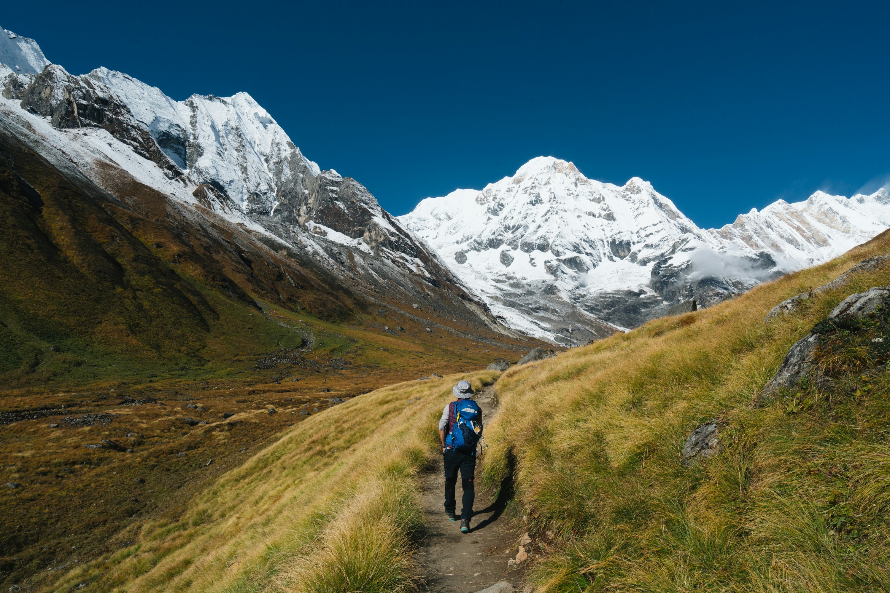 Image of a trekker on a trail in the Annapurna mountain range in Nepal - KILROY