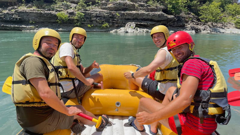 Image of a group of male travellers rafting in the Balkans - KILROY