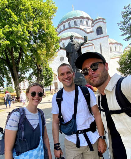 Image of a group of travellers in front of a church in Albania - KILROY