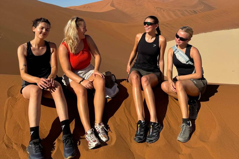 Image of a group of female travellers on a sand dune in Namibia - KILROY