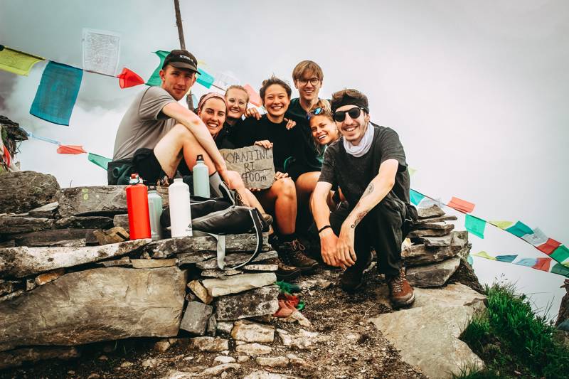 Image of a group of young travellers at the base camp on a mountain - KILROY