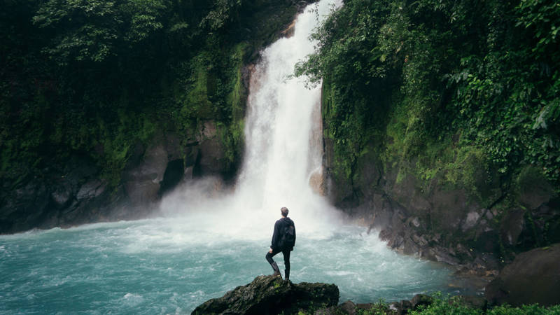 Image of a male traveller at a waterfall - KILROY