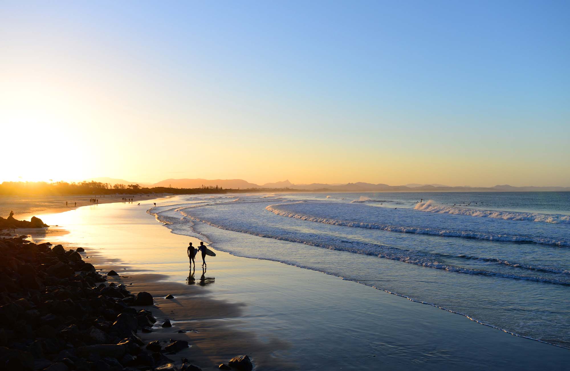 Image of two surfers on a beach at sunset in Australia - KILROY