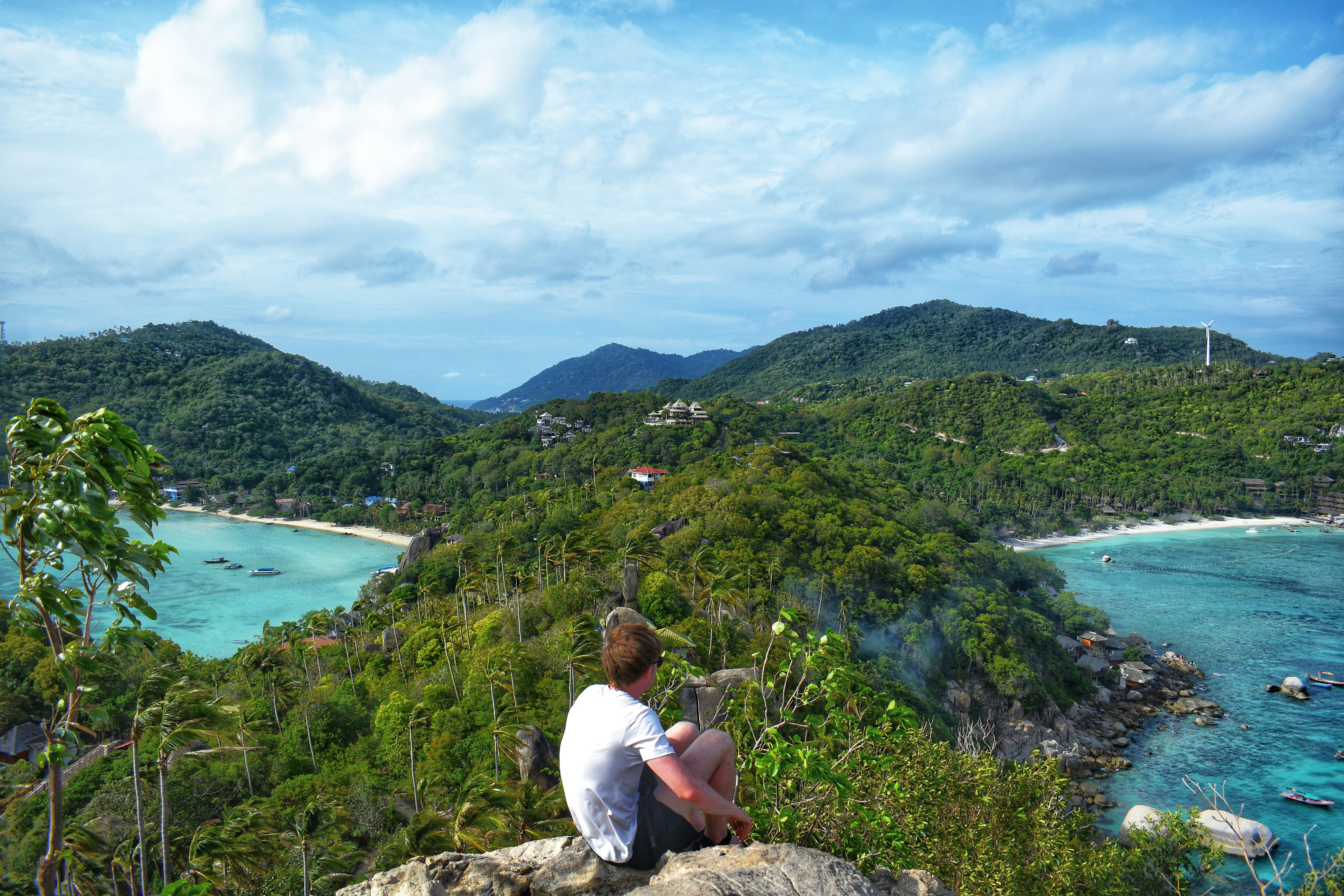 Image of a young male traveller looking out at Koh Tao Island in Thailand on his gap year - KILROY