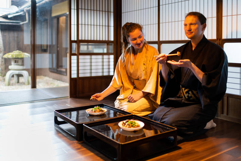 Image of a couple eating at a traditional Japanese inn in Japan - KILROY