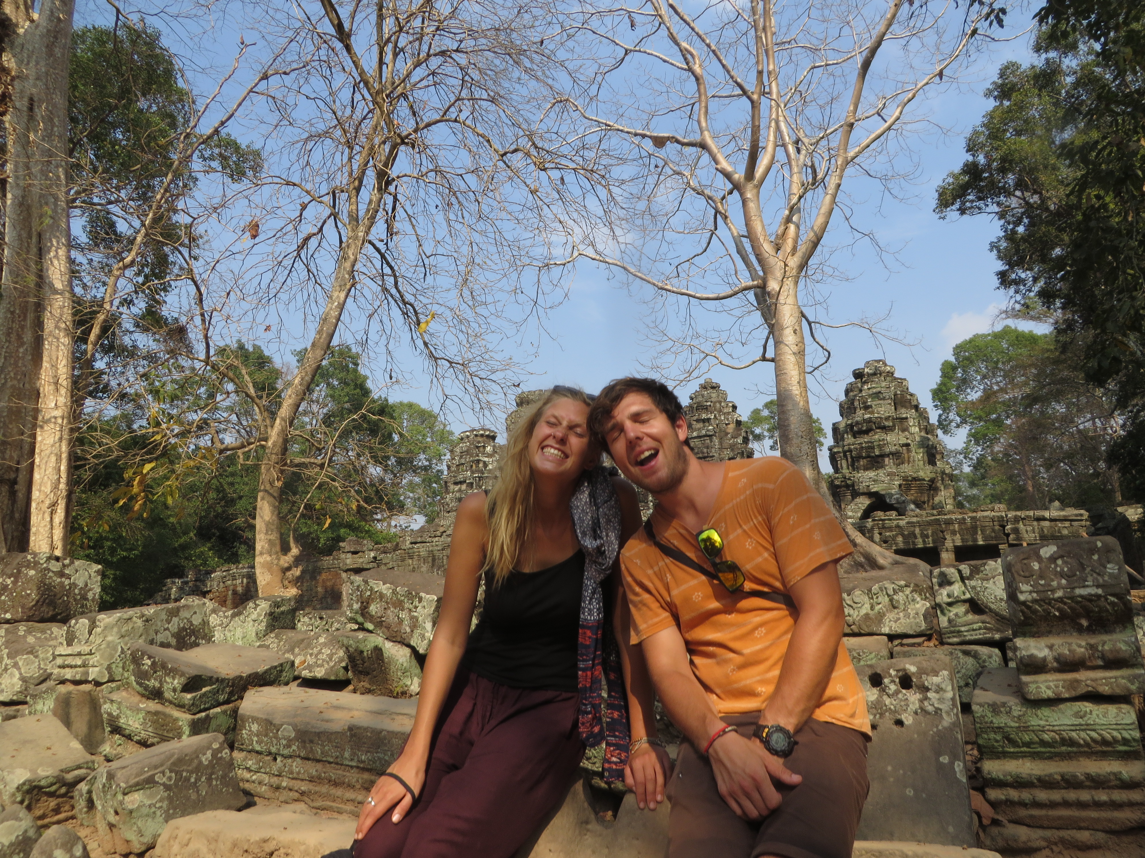 Image of a young couple posing in front of a temple in Angkor Wat in Cambodia - KILROY