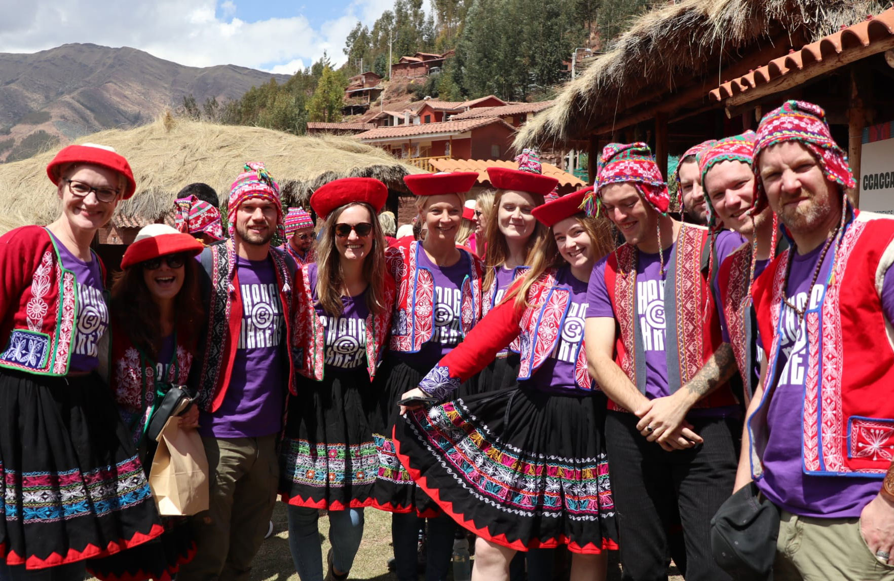 Image of a group of travellers in traditional Andean clothing in Peru - KILROY