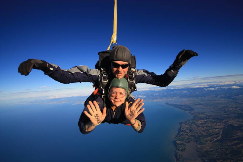 Image of a woman during a tandem skydive - KILROY