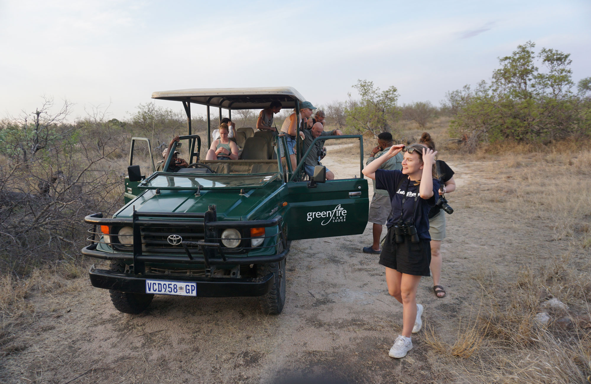 Image of a group of people near a safari truck in South Africa - KILROY