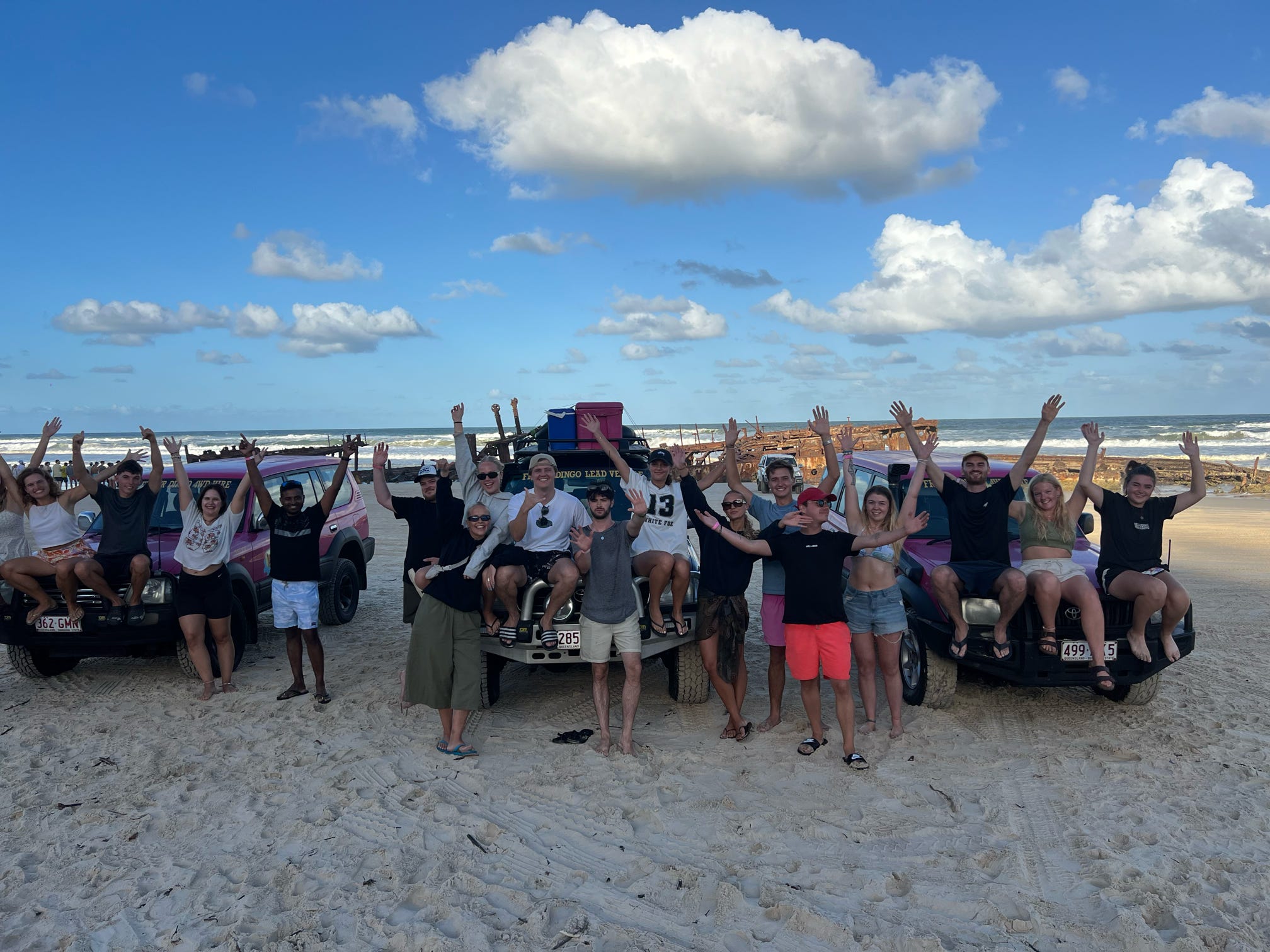 Image of a group of travellers posing in front of jeeps on K'gari island in Australia - KILROY