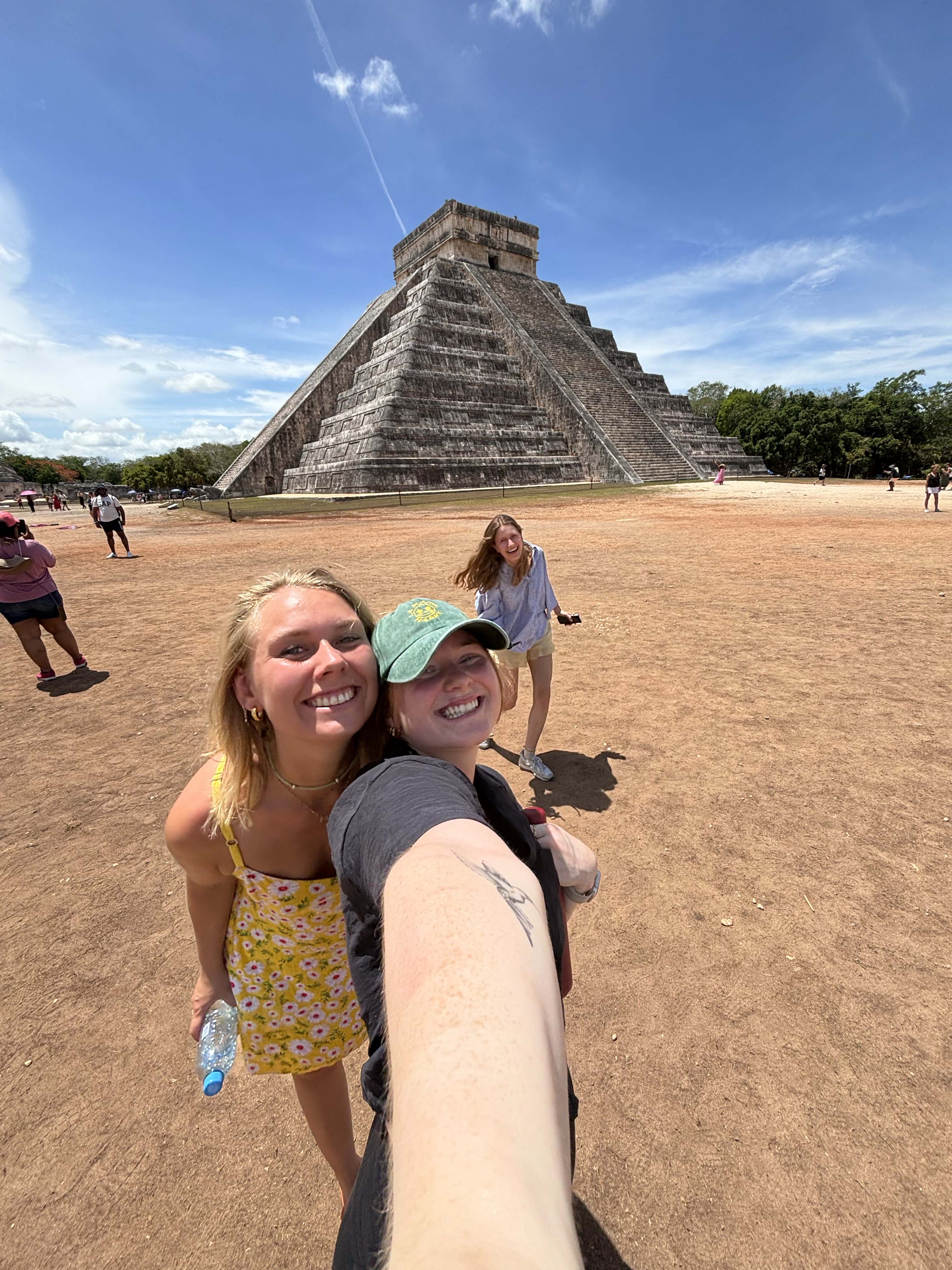 Image of young female travellers posing in front of Chichen Itza in Mexico - KILROY
