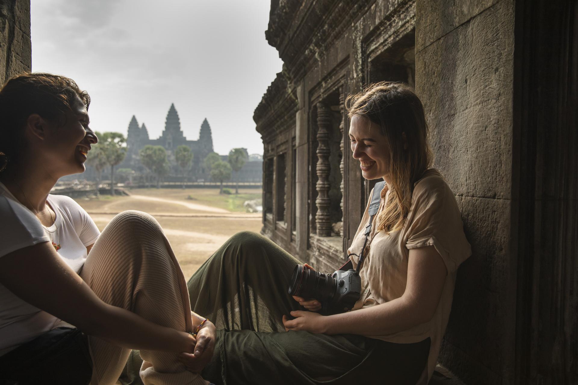 Cambodia Siem Reap Angkor Wat Temple Female Travellers Sitting Laughing