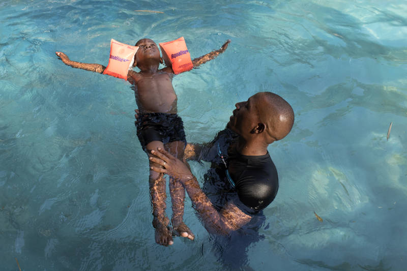Image of a young child learning to swim in Eswatini - KILROY